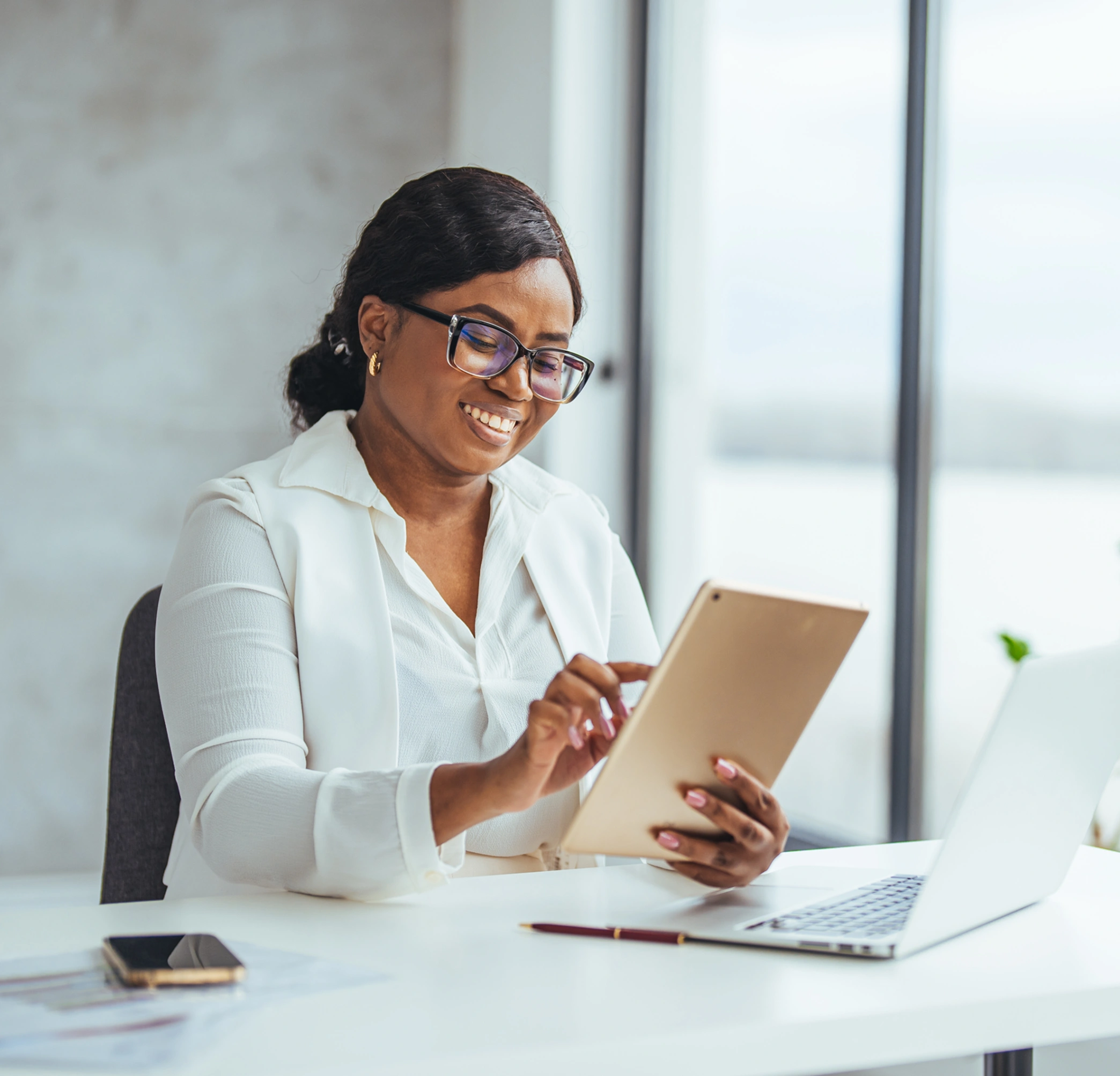 Woman using a tablet at her desk